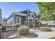 Charming ranch home with a gray exterior, brick accents, and a well-maintained lawn at 607 Summer Hawk Dr, Longmont, CO 80504