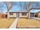 Ranch home with a blue door and gray garage at 1514 S Chase Ct, Lakewood, CO 80232