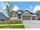 Inviting curb appeal with two-car garage and landscaping at 8668 S Quatar St, Aurora, CO 80016