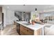 Modern kitchen island with sink and views into living room at 3580 W 62Nd Pl, Denver, CO 80221