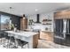 Modern kitchen with island, stainless steel appliances, and wood cabinets at 3580 W 62Nd Pl, Denver, CO 80221