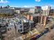 Aerial view of modern townhouses with city skyline in background at 1811 N Williams St, Denver, CO 80218