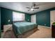 Spacious bedroom with a king-size bed and green walls at 4673 S Lowell Blvd, Denver, CO 80236