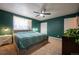 Spacious bedroom with king bed and green walls at 4673 S Lowell Blvd, Denver, CO 80236