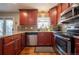 Updated kitchen featuring wood cabinets and granite countertops at 4673 S Lowell Blvd, Denver, CO 80236