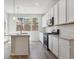 Modern kitchen with white cabinets and large island at 465 Interlocken Blvd # 101, Broomfield, CO 80021