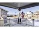 Covered porch with white railing, American flag, and mountain view at 998 Larkspur Dr, Erie, CO 80516