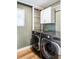 Laundry room with LG washer and dryer, and cabinets at 998 Larkspur Dr, Erie, CO 80516