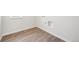 Laundry room with wood-look flooring and built-in shelving at 3322 N Highlands Creek Pkwy, Aurora, CO 80019