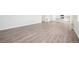 Open living area with light gray vinyl plank flooring and kitchen views at 3322 N Highlands Creek Pkwy, Aurora, CO 80019