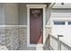 Exterior view of a charming home's front entrance with a burgundy door at 3322 N Highlands Creek Pkwy, Aurora, CO 80019