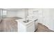 Kitchen island with stainless steel sink and dishwasher, open to living area at 3322 N Highlands Creek Pkwy, Aurora, CO 80019