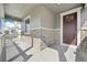 View of a welcoming front porch with stone accents and a burgundy front door at 3322 N Highlands Creek Pkwy, Aurora, CO 80019