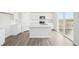 Bright kitchen featuring an island, stainless steel appliances, and access to a deck at 3322 N Highlands Creek Pkwy, Aurora, CO 80019