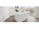 Open concept kitchen with a large island and a view to backyard deck at 3322 N Highlands Creek Pkwy, Aurora, CO 80019