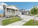 Two-story home with gray siding, white trim, and a two-car garage at 3322 N Highlands Creek Pkwy, Aurora, CO 80019