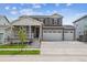 Two-story home with gray siding, white trim, and a three-car garage at 3322 N Highlands Creek Pkwy, Aurora, CO 80019