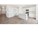 Modern kitchen with white cabinets, island, and stainless steel appliances at 3322 N Highlands Creek Pkwy, Aurora, CO 80019