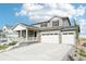 Two-story home with gray siding, white trim, and a three-car garage at 3322 N Highlands Creek Pkwy, Aurora, CO 80019