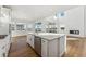 Open concept kitchen with island, stainless steel appliances, and white cabinetry at 39650 Congress Ln, Elizabeth, CO 80107