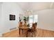 Bright dining room with a round table and chairs, and a kitchen view at 9971 Bronti Cir, Lone Tree, CO 80124