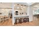 Modern kitchen with breakfast bar and white cabinetry at 9971 Bronti Cir, Lone Tree, CO 80124