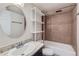 Clean bathroom with a shower/tub combo, granite vanity, and white shelving at 909 N Logan St # 4A, Denver, CO 80203