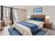 Main bedroom with wood flooring and access to a private balcony at 909 N Logan St # 4A, Denver, CO 80203