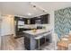 Modern kitchen with dark cabinetry, granite countertops, and stainless steel appliances at 909 N Logan St # 4A, Denver, CO 80203