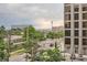 View of city street with traffic, buildings and distant mountains at 909 N Logan St # 4A, Denver, CO 80203