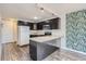 Updated kitchen, featuring dark cabinetry and granite countertops at 909 N Logan St # 4A, Denver, CO 80203