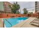Inviting rectangular pool with surrounding lounge chairs and a shaded area at 909 N Logan St # 4A, Denver, CO 80203