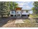White ranch house with black accents, a covered porch, and steps leading to the entrance at 5142 Buffalo Rd, Erie, CO 80516