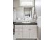 Elegant bathroom with marble tile, white vanity, and updated fixtures at 215 Monroe St, Denver, CO 80206