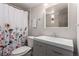 Bathroom with floral shower curtain and updated vanity at 8060 E Girard Ave # 719, Denver, CO 80231