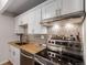 Modern kitchen with updated appliances and butcher block countertops at 8060 E Girard Ave # 719, Denver, CO 80231