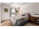 Bright bedroom with double bed, dresser, and large window at 8060 E Girard Ave # 719, Denver, CO 80231