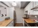 Modern kitchen with butcher block countertops and stainless steel appliances at 8060 E Girard Ave # 719, Denver, CO 80231