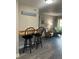 Breakfast bar with two black stools, gray walls, and wood countertop at 4899 S Dudley St # 1E, Littleton, CO 80123