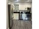 Modern kitchen featuring stainless steel appliances and white cabinets at 4899 S Dudley St # 1E, Littleton, CO 80123