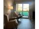 Living room with two armchairs, balcony view, and wood-look floors at 4899 S Dudley St # 1E, Littleton, CO 80123