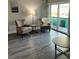 Living room with two armchairs and a sliding door to balcony at 4899 S Dudley St # 1E, Littleton, CO 80123