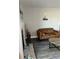 Living room with brown couch, fireplace, and wood-look floors at 4899 S Dudley St # 1E, Littleton, CO 80123