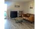 Living room with fireplace, wood-look floors, and a comfy brown leather couch at 4899 S Dudley St # 1E, Littleton, CO 80123