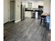 Open living area with gray floors and access to the kitchen at 4899 S Dudley St # 1E, Littleton, CO 80123