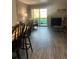 View of living room, dining area, and access to balcony at 4899 S Dudley St # 1E, Littleton, CO 80123