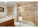 Clean bathroom with a shower/tub combo and updated fixtures at 1901 S Newport, Denver, CO 80224