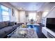 Open living area with hardwood floors, modern furniture, and ample natural light at 11255 E 25Th Ave, Aurora, CO 80010