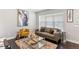 Spacious living room featuring a large window, comfortable seating, and stylish decor at 11255 E 25Th Ave, Aurora, CO 80010