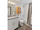 Clean bathroom with white vanity, tub, shower, and gray tile floor at 11255 E 25Th Ave, Aurora, CO 80010